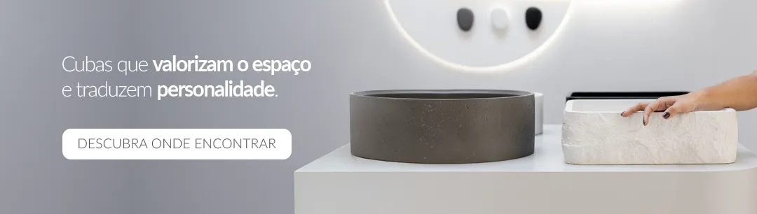 Cubas Geostone Doka expostas sobre bancada com design sofisticado; à esquerda cuba redonda em tom escuro e à direita cuba branca sendo tocada por uma mão. Texto na imagem: 'Cubas que valorizam o espaço e traduzem personalidade'.