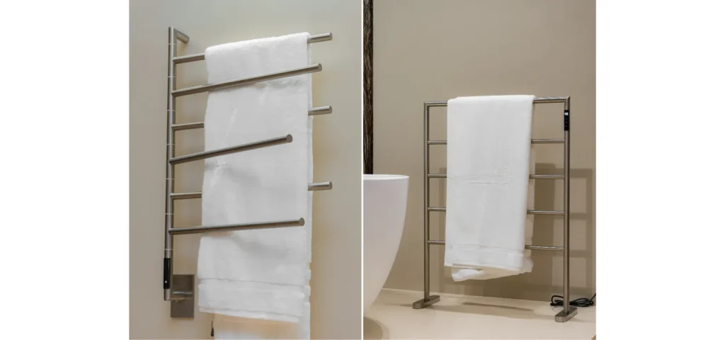 Banheiros modernos Doka 2026: à esquerda, Toalheiro Térmico Articulado fixado na parede em aço inox escovado com barras cilíndricas e toalha branca; à direita, Toalheiro Térmico de Piso em aço inox escovado com estrutura autoportante e barras retangulares, exibindo toalha branca dobrada, posicionado ao lado de vaso sanitário em ambiente clean.